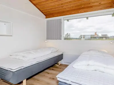 two beds in a room with a window at Type2 holiday home in Hanstholm in Hanstholm