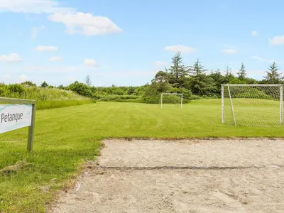 a soccer field with a sign next to a goal at Vegsø Holiday Park Premium Retreat in Hanstholm