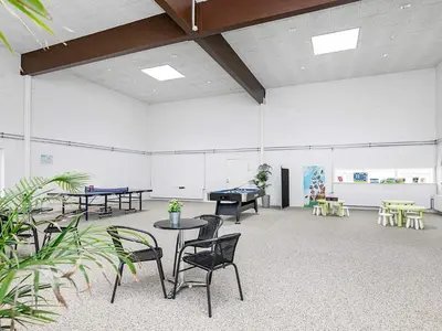 a large room with ping pong tables and chairs at 6 person holiday home in Brovst in Brovst