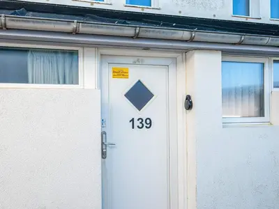 a white door with the number on it at 6 person holiday home in Brovst in Brovst