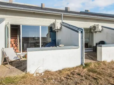 an open door of a building with a chair in front at 6 person holiday home in Brovst in Brovst
