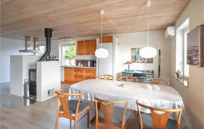 a kitchen and dining room with a table and chairs at 3 Bedroom Cozy Home In Fur in Fur