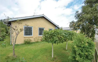 a yellow house with two trees in the yard at 3 Bedroom Cozy Home In Fur in Fur