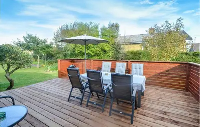 a table and chairs with an umbrella on a deck at 3 Bedroom Cozy Home In Fur in Fur