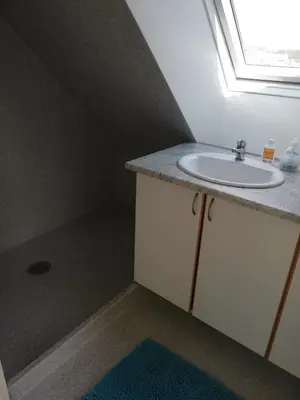 a bathroom with a sink and a window at Hunetorpvej Holiday Apartment in Blokhus