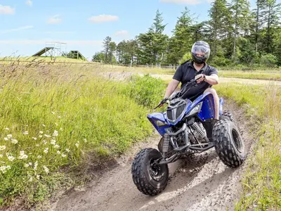 a man riding a dirt bike down a dirt road at Vigsø Holiday Center in Hanstholm