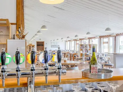 a bar in a restaurant with wine bottles at Vigsø Holiday Center in Hanstholm