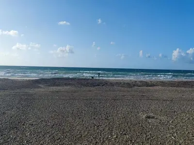 an empty beach with the ocean in the background at 6 person holiday home in Brovst in Brovst