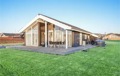 a small house with a deck and a lawn at Lovely Home In Vinderup With Wifi in Vinderup