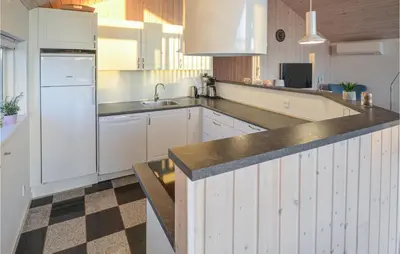 a kitchen with white cabinets and a counter top at Lovely Home In Vinderup With Wifi in Vinderup