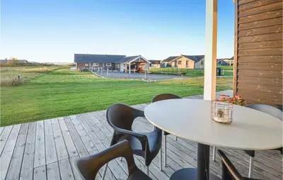 a table and chairs on a patio with a view of a yard at Lovely Home In Vinderup With Wifi in Vinderup
