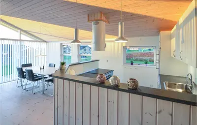 a kitchen and dining room with a table and chairs at Lovely Home In Vinderup With Wifi in Vinderup