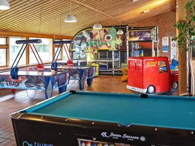a play room with a pool table and a arcade at Room in Vigsø Holiday Park in Hanstholm