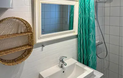 a bathroom with a sink and a mirror and a shower at 3 Bedroom Stunning Home In Snedsted in Snedsted