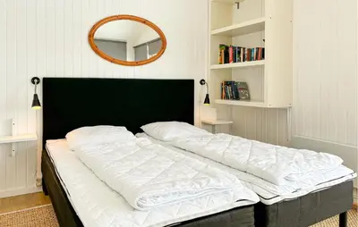 a large bed in a bedroom with a mirror at 3 Bedroom Stunning Home In Snedsted in Snedsted