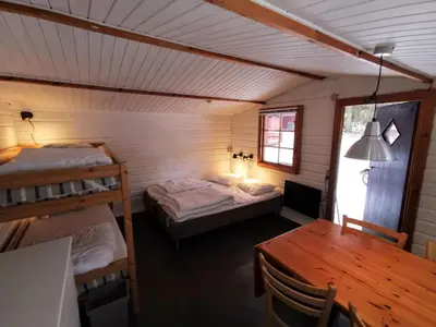 a room with two bunk beds and a table at Glyngøre Camping in Glyngøre