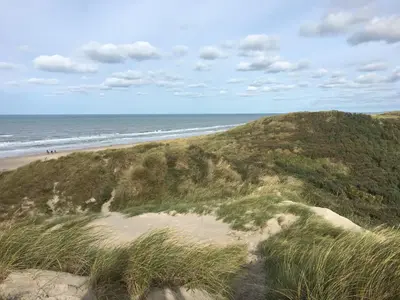 a sandy beach with the ocean in the background at Rødhus Gl. Skole B&B in Pandrup