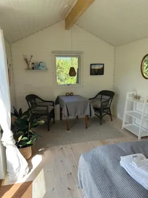 a room with a table and chairs and a window at Rødhus Gl. Skole B&B in Pandrup