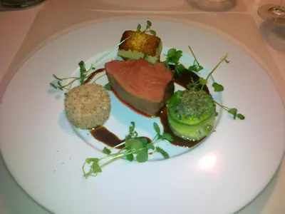 a plate of food with meat and vegetables on a table at Aars Hotel in Års