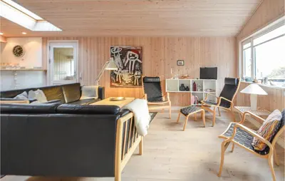 a living room with a black couch and chairs at Amazing Home In Thisted With Kitchen in Thisted