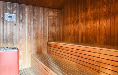 a sauna with wooden walls and a wooden floor at Feriehotel Tranum Klit in Brovst