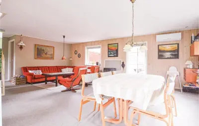 a living room with a white table and chairs at Fjordens Perle in Farsø
