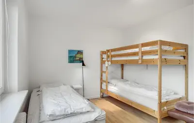 a bedroom with two bunk beds and a lamp at 2 Bedroom Lovely Home In Thisted in Thisted