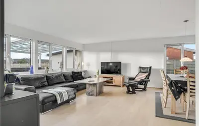 a living room with a couch and a television at 2 Bedroom Lovely Home In Thisted in Thisted