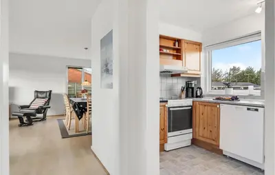 a kitchen with white appliances and a dining room at 2 Bedroom Lovely Home In Thisted in Thisted