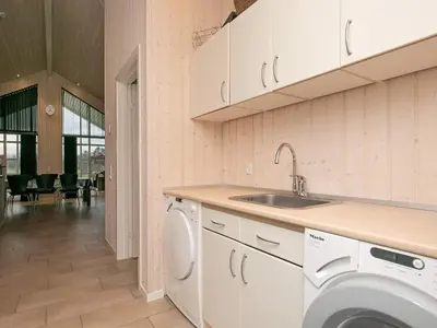 a kitchen with a sink and a washing machine at 15 person holiday home in Højslev in Højslev
