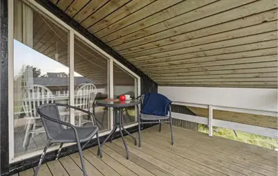 a patio with chairs and a table on a deck at Gorgeous Home In Thisted With Sauna in Thisted
