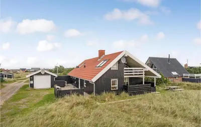 a house with a red roof on top of a field at Gorgeous Home In Thisted With Sauna in Thisted