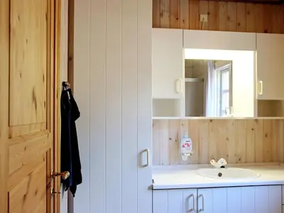 a bathroom with a sink and a mirror at Secluded Forest Retreat at Gjol-By Traum in Åbybro