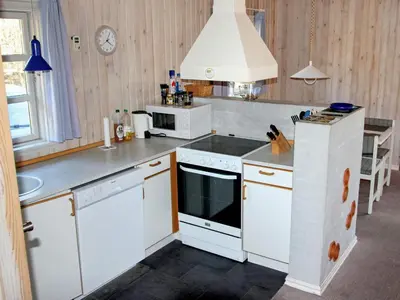 a kitchen with white appliances and a stove top oven at Secluded Forest Retreat at Gjol-By Traum in Åbybro