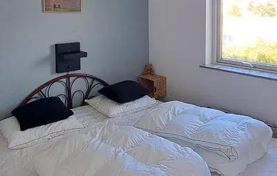 a bedroom with a white bed with two pillows at Nice Home In Thisted With Sauna in Thisted