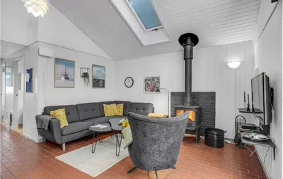 a living room with a couch and a fireplace at Nice Home In Thisted With Sauna in Thisted