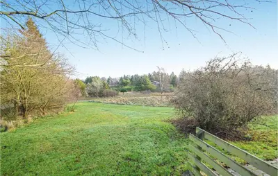 a park bench sitting in a field of grass at 2 Bedroom Beautiful Home In Fur in Fur