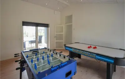 a room with two ping pong tables in it at 4 Bedroom Cozy Home In Spøttrup in Spottrup