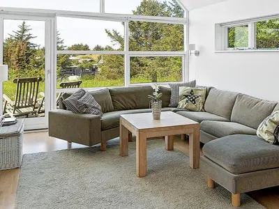 a living room with a couch and a coffee table at 6 person holiday home in Blokhus in Blokhus