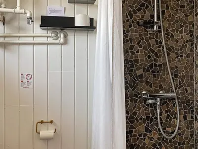 a bathroom with a shower with a shower curtain at 6 person holiday home in Thisted in Torsted