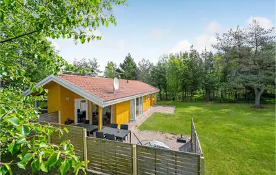 a yellow house with a fence and a yard at Stunning Home In Fjerritslev With Wifi in Fjerritslev