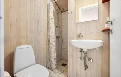 a bathroom with a toilet and a sink at Stunning Home In Fjerritslev With Wifi in Fjerritslev