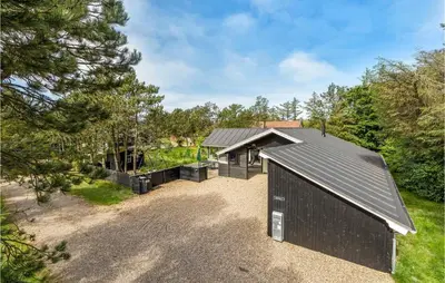 an exterior view of a house with a garage at 4 Bedroom Beautiful Home In Vestervig in Vestervig