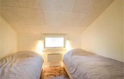 a bedroom with two beds and a window at 4 Bedroom Beautiful Home In Vestervig in Vestervig