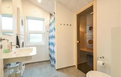 a bathroom with a sink and a toilet at 4 Bedroom Beautiful Home In Vestervig in Vestervig