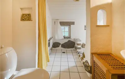 a bathroom with a sink and a toilet in a room at Cozy Home In Thyholm With Wifi in Thyholm