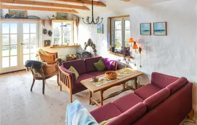 a living room with a couch and a table at Cozy Home In Thyholm With Wifi in Thyholm