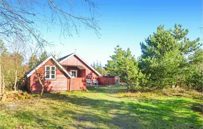 a small red house in a yard with trees at Nice Home In Hurup Thy in Sønder Ydby