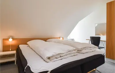 a bedroom with two beds with white pillows at Lovely Apartment In Lemvig With Kitchen in Lemvig