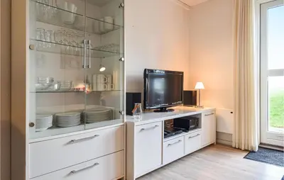 a living room with a tv and a white cabinet at Lovely Apartment In Lemvig With Kitchen in Lemvig